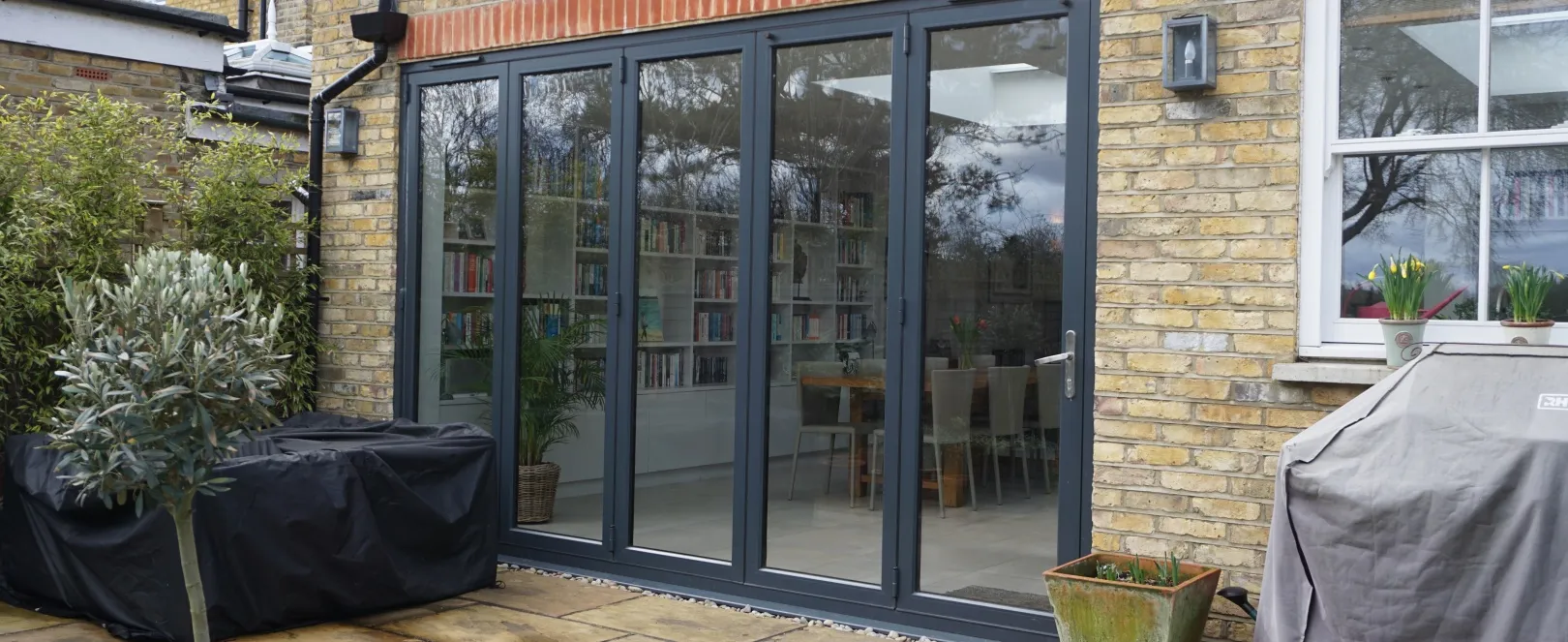 Rear extension with aluminium bifold doors opening onto a garden patio